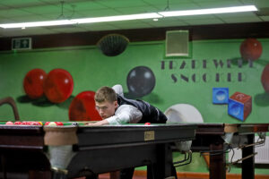 Matthew Haslam down on a shot at the Tradewell Snooker Club in Hull