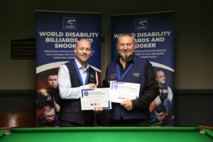 Dave Bolton and Dalton Lawrence shake hands and show off their medals and certificates following the final of the 2023 UK Disability Snooker Championship