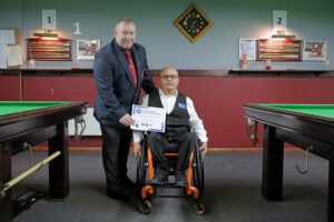 Tournament Director Stuart Barker presents Neville Helou with his certificate at the 2024 Hull Open