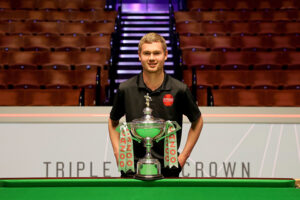 Matthew Haslam with the World Snooker Championship trophy on the Crucible Theatre arena floor