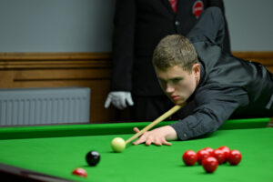 Matthew Haslam lines up a black off the spot during a match