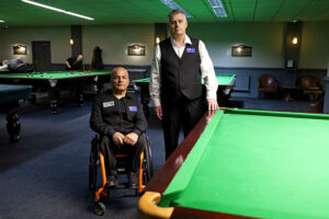 Neville Helou and Dave Nicholson pose by the table in Northampton after travelling from Australia for the event