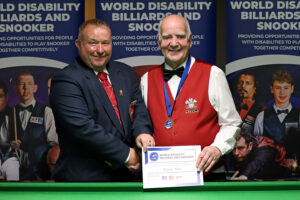 Ronnie Allen shakes hands with tournament director Stuart Barker after winning the Challenge Cup