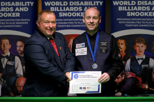 Dave Bolton receives his medal and certificate from tournament director Stuart Barker