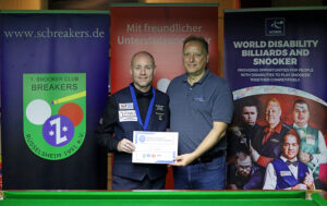 Dave Bolton receives his medal and certificate after victory at the German Open