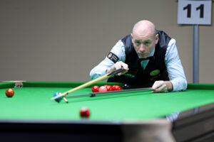 Dave Bolton plays a snooker shot with the rest