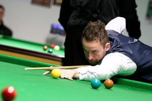 Mickey Chambers plays a snooker shot