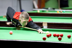 David Church plays a shot on the snooker table