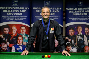 Kristof De Bruyn poses by the tables with the balls set up in the colours of the Belgium flag