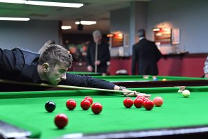 Luke Drennan plays a snooker shot