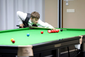 Luke Drennan plays a snooker shot