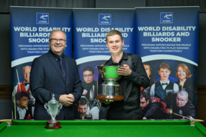 WDBS Chairman Nigel Mawer QPM hands Matthew Haslam the Champion of Champions trophy