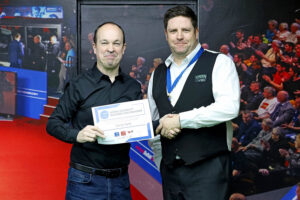 Fergal O'Brien presents Daniel Kelly with his medal and certificate following his victory