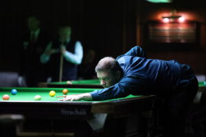 Lewis Knowles plays a shot on the snooker table