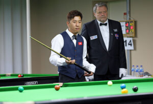 Andy Lam prepares to play a snooker shot