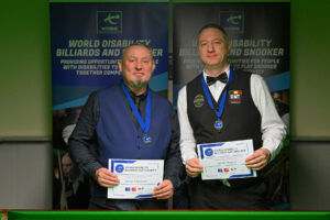 Dalton Lawrence and Gerdy Dupont pose together with certificates at an event