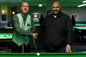 Alan Reynolds and Mohammed Faisal Butt shake hands before their final