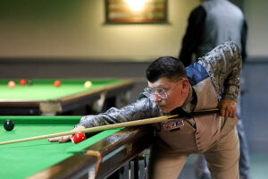 Leroy Williams plays a shot on the snooker table